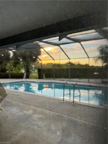 View of pool with glass enclosure