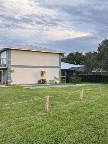 View of home's exterior featuring a yard and a lanai