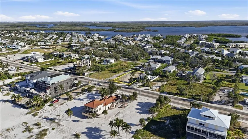 Aerial overview of property's location with nearby suburban area and a large body of water - Virtually Edited Image