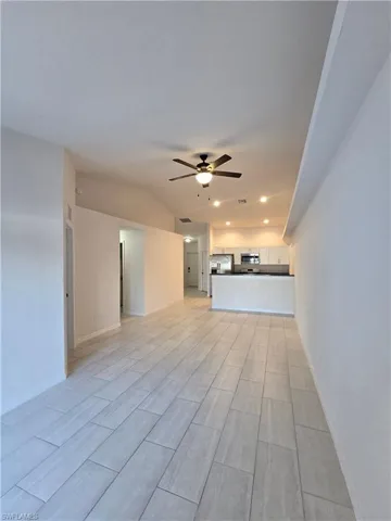 Unfurnished living room with ceiling fan, recessed lighting, and wood finish floors