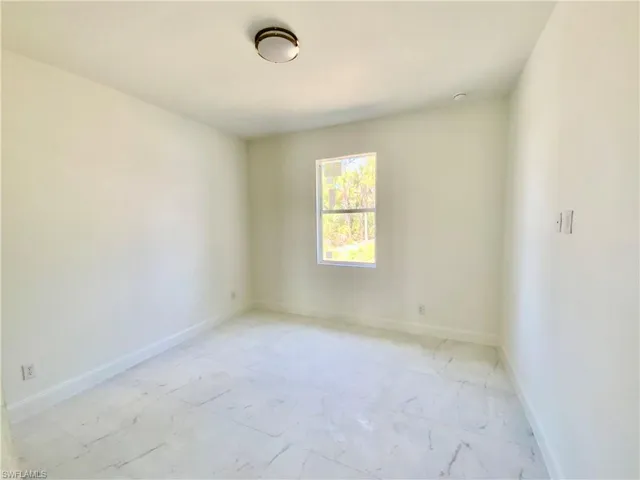 Spare room featuring light tile patterned floors