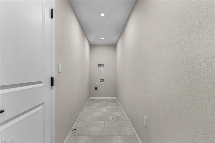 Laundry area with electric dryer hookup, recessed lighting, washer hookup, and tile patterned floors