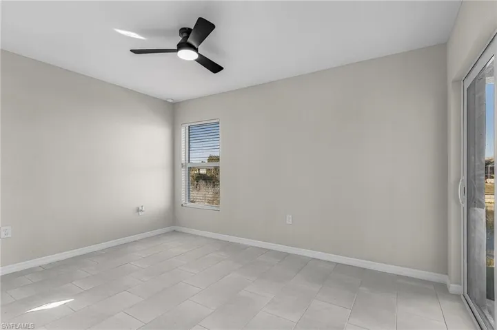 Spare room with baseboards and a ceiling fan