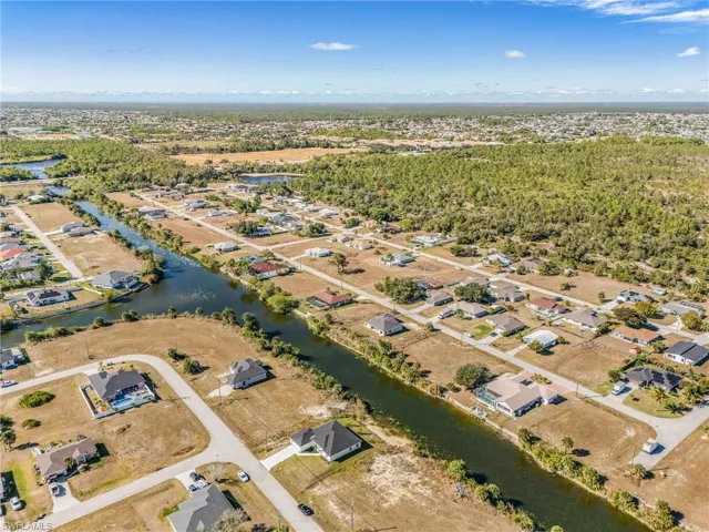 Aerial view of property's location with nearby suburban area and a large body of water