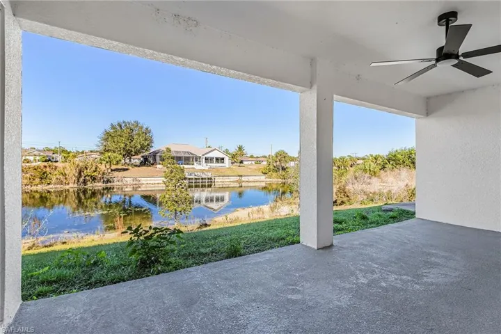 View of patio with a ceiling fan, a water view, and a residential view