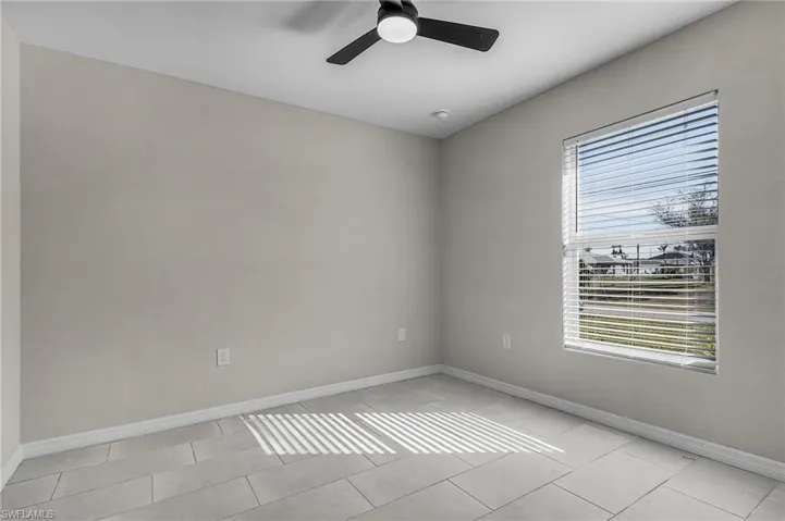 Spare room with baseboards and ceiling fan