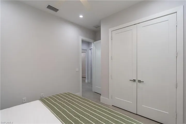 Unfurnished bedroom featuring a closet, ceiling fan, recessed lighting, and concrete flooring