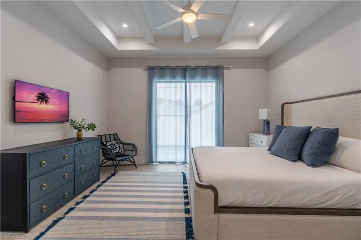 Bedroom featuring ceiling fan, beamed ceiling, and recessed lighting