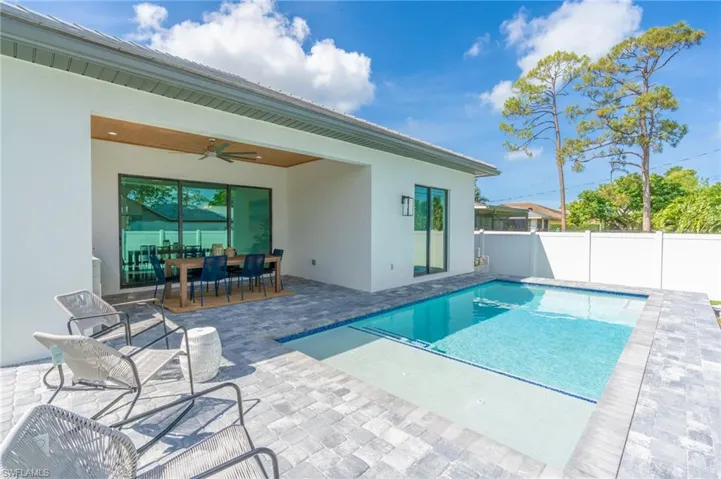 View of swimming pool with a patio area, outdoor dining area, and a fenced backyard