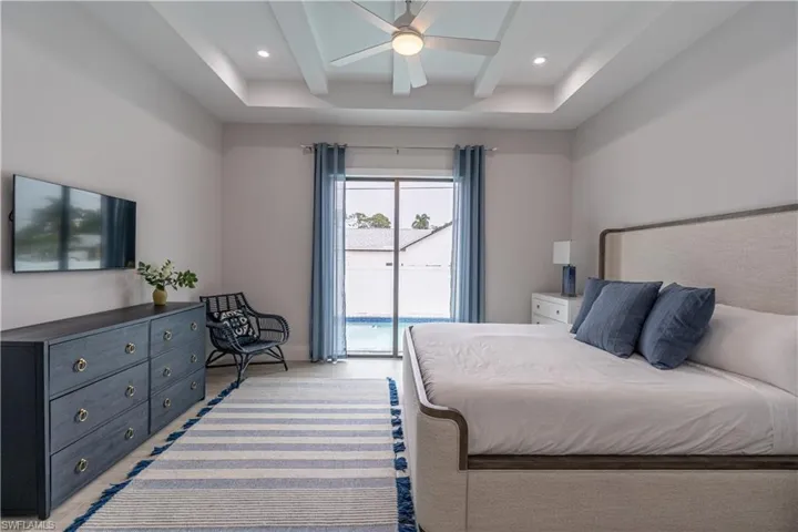 Bedroom featuring access to outside, beam ceiling, a ceiling fan, and recessed lighting