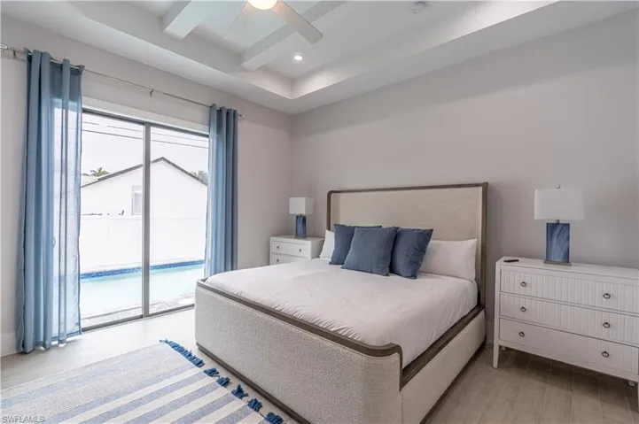 Bedroom with access to exterior, light wood-type flooring, a ceiling fan, and recessed lighting