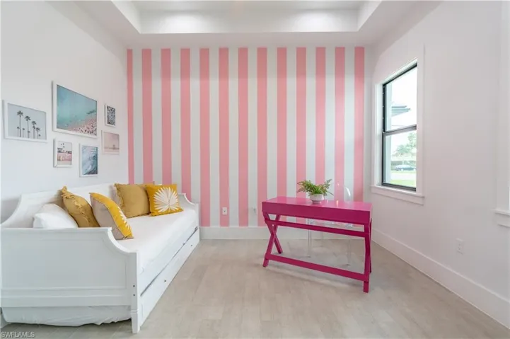 Sitting room featuring baseboards and wood finished floors