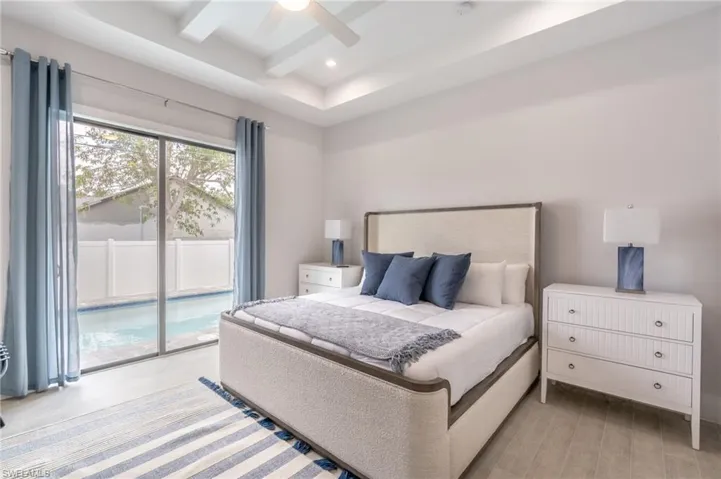 Bedroom with access to exterior, ceiling fan, recessed lighting, and beam ceiling