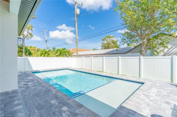View of pool with a fenced backyard and a patio area