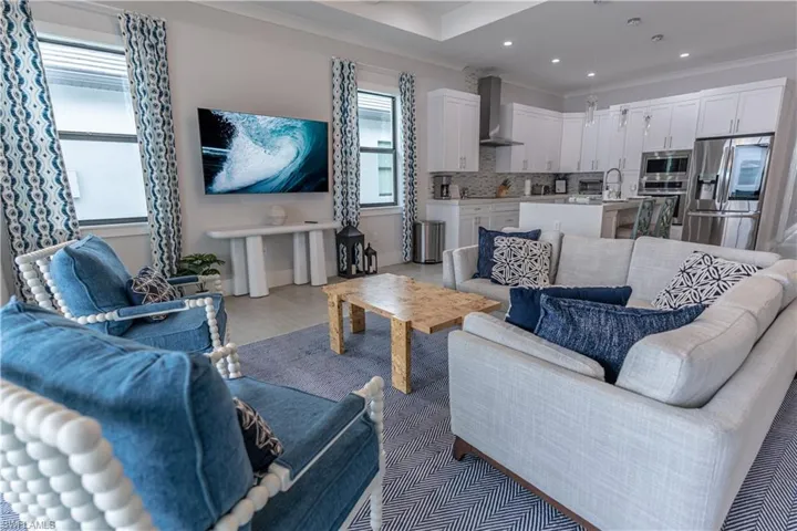 Living room featuring ornamental molding and recessed lighting