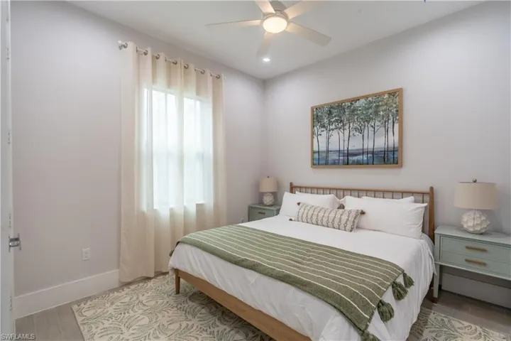 Bedroom featuring wood finished floors and ceiling fan