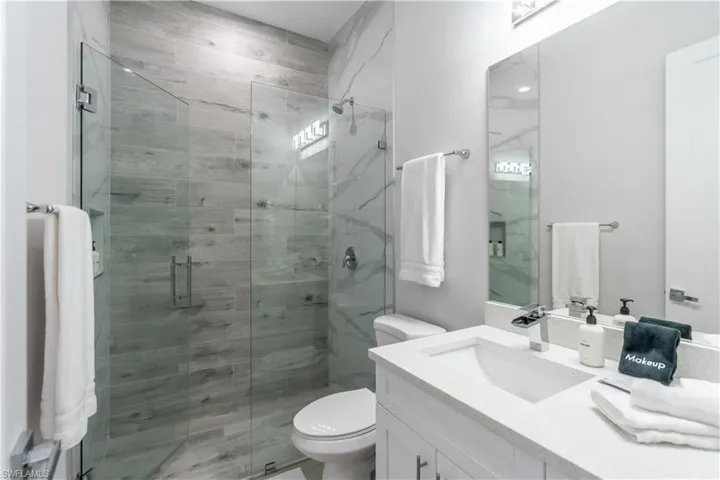 Full bath with vanity and a stall shower