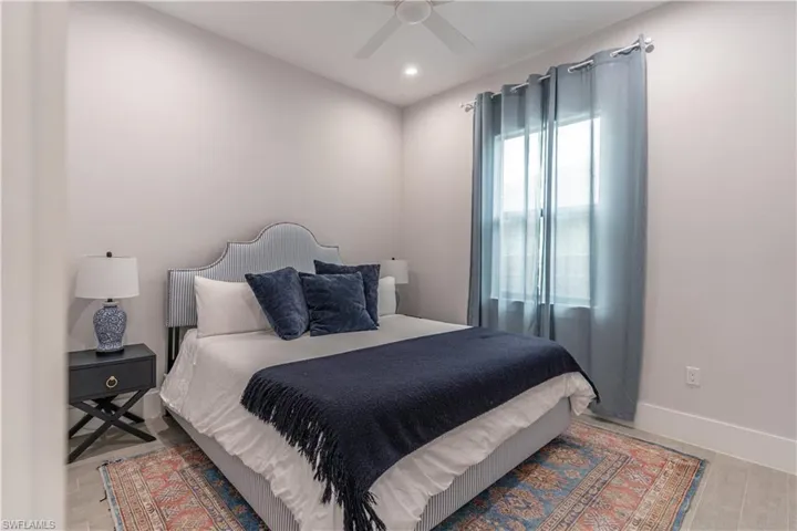 Bedroom with a ceiling fan, recessed lighting, and wood finished floors