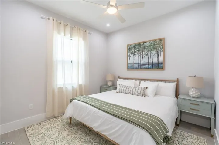 Bedroom with a ceiling fan, wood finished floors, and recessed lighting
