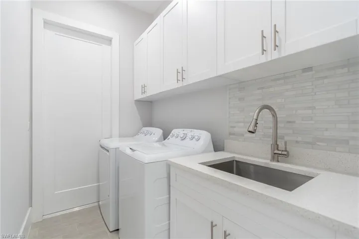 Laundry room with washer and dryer and cabinet space