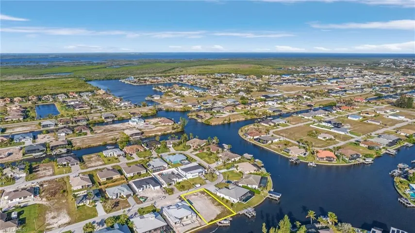 Gulf Access lot with seawall, boat dock and lift northeastern rear exposure, about 20 min by boat to open water. 907 NW 38th Ave, Cape Coral FL 33993
