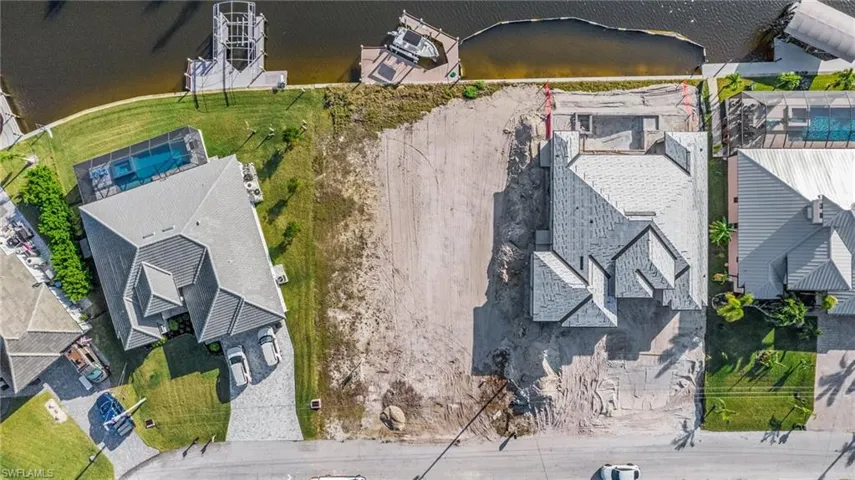 Gulf Access lot with seawall, boat dock and lift northeastern rear exposure, about 20 min by boat to open water. 907 NW 38th Ave, Cape Coral FL 33993