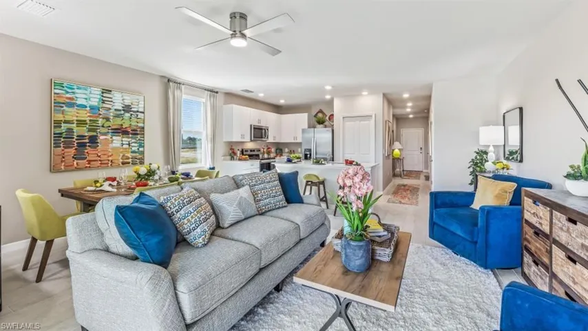 Living room featuring ceiling fan and light wood-type flooring