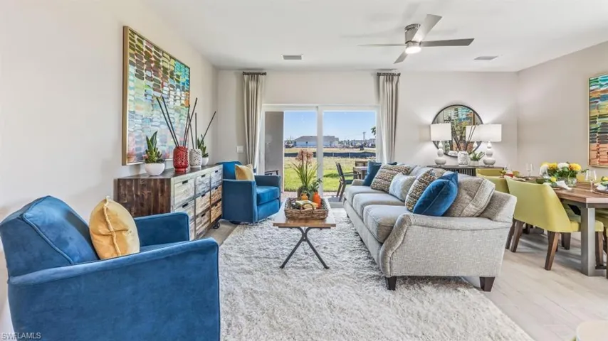 Living room with ceiling fan and light wood-type flooring