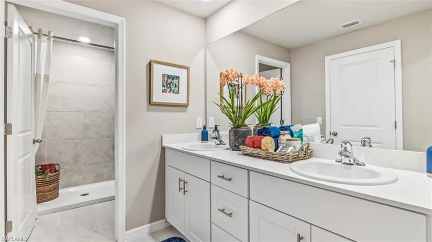 Bathroom with vanity and a tile shower