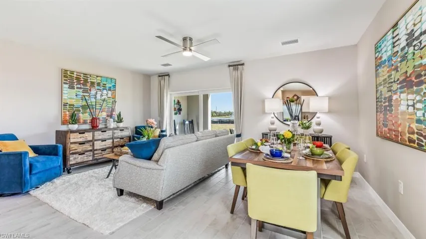 Living room with ceiling fan and light hardwood / wood-style floors