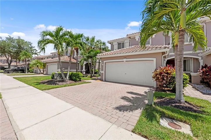 Mediterranean / spanish-style house with stucco siding, decorative driveway, a garage, and a tile roof