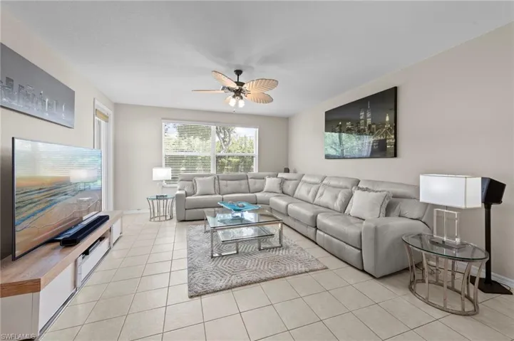 Living room featuring ceiling fan and light tile patterned floors