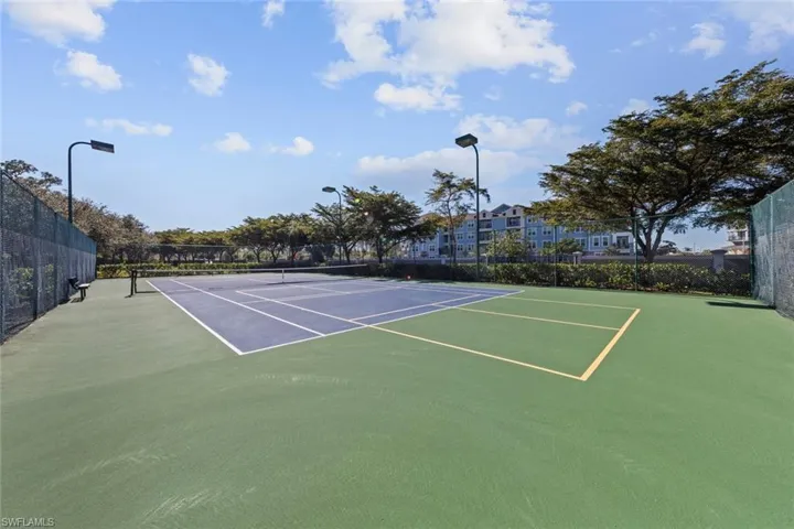 View of tennis court with community basketball court