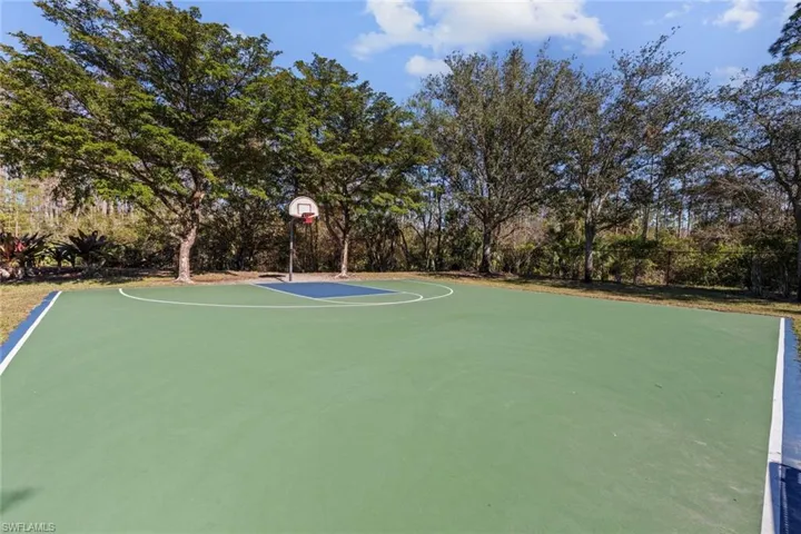 View of sport court featuring community basketball court and view of scattered trees