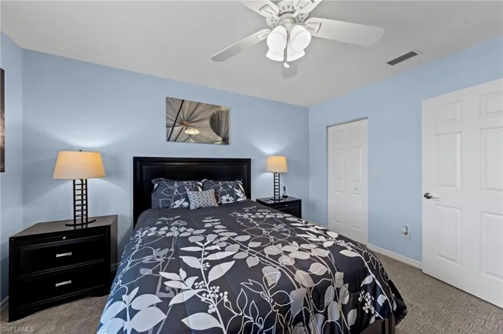 Bedroom with carpet, ceiling fan, and a closet