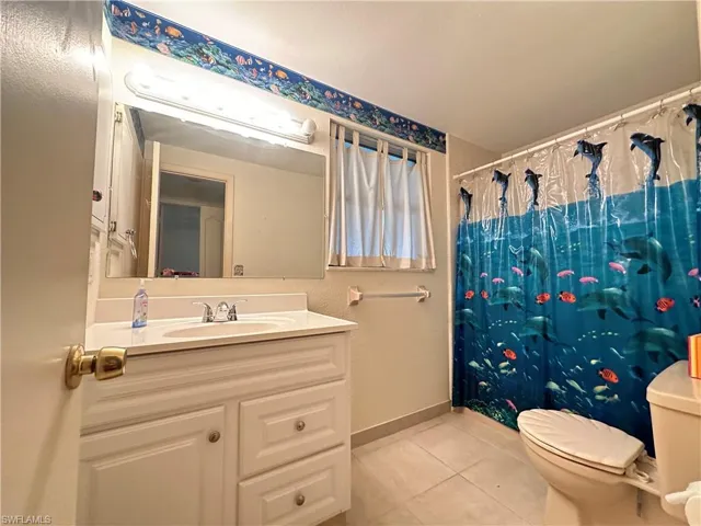 Bathroom 2 featuring tile flooring, oversized vanity, and toilet