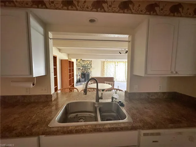 Kitchen featuring sink and white cabinetry