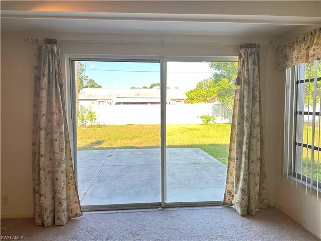 Doorway to outside with carpet
