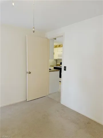 View of carpeted primary bedroom entry