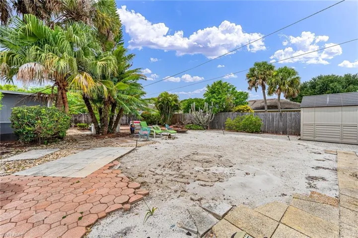 View of yard with a patio and a shed