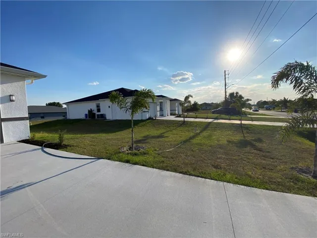 View of front of property with a front lawn and a garage