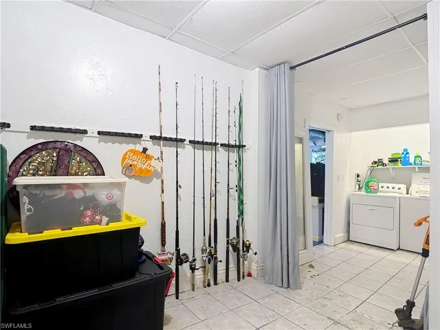Laundry area featuring washer and clothes dryer and a paneled ceiling