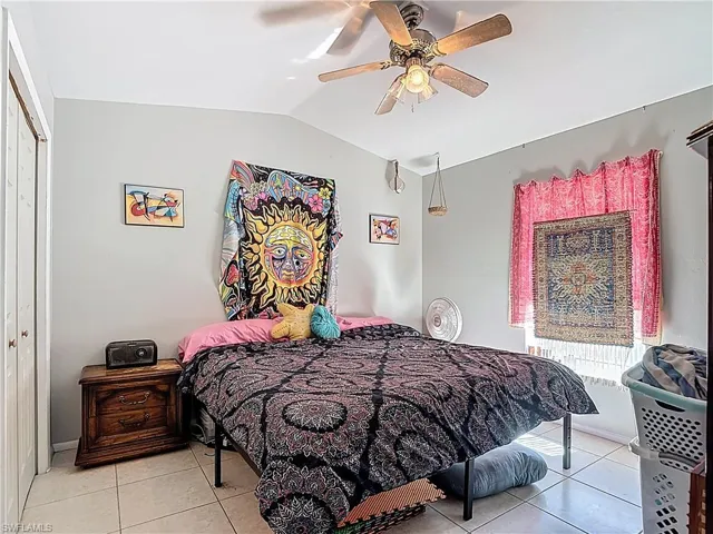 Tiled bedroom featuring a closet and a ceiling fan