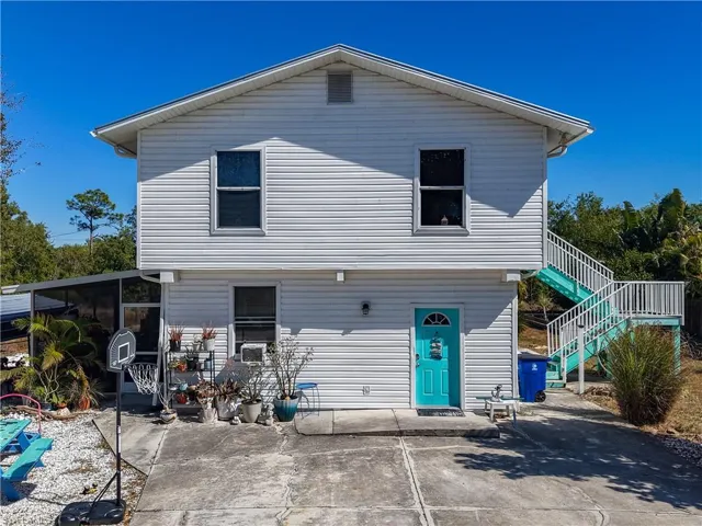 View of front of property featuring stairway and a patio area