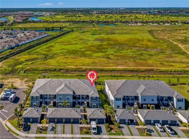 Aerial perspective of suburban area with a nearby body of water