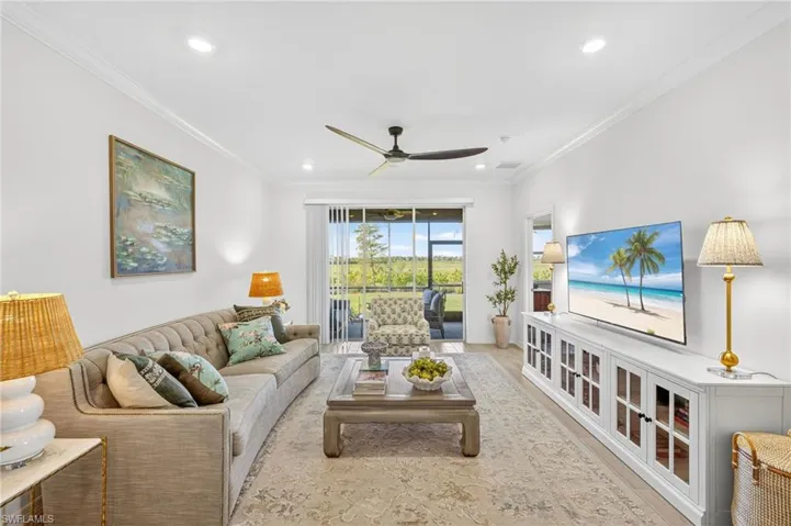 Living area featuring ornamental molding, ceiling fan, wood finished floors, and recessed lighting