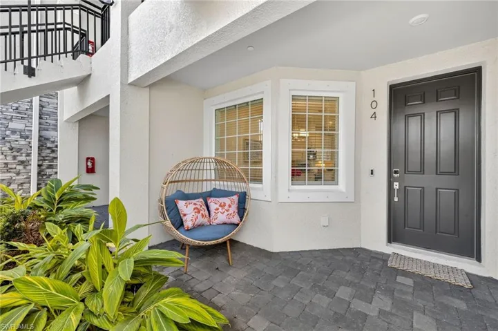 Property entrance with stucco siding and a patio