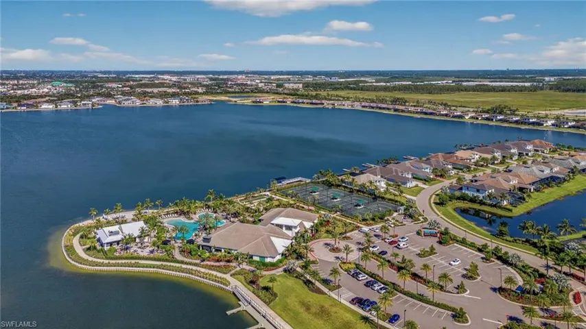Aerial view of property's location with a large body of water and nearby suburban area