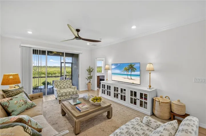 Living area featuring crown molding, wood finished floors, ceiling fan, and recessed lighting