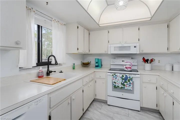Kitchen featuring light countertops and white appliances